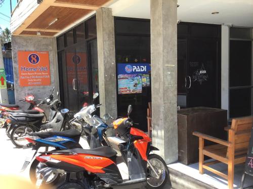 a row of motorcycles parked outside of a building at 8 homestel in Koh Tao