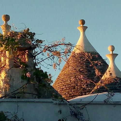 two domes on top of a brick building at Trulli di Ivana in Ostuni