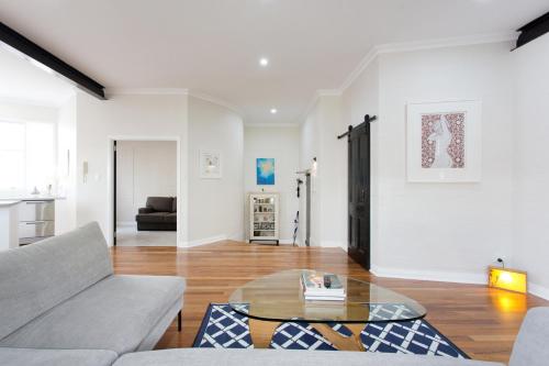 a living room with a couch and a table at Hidden Treasure in Fremantle