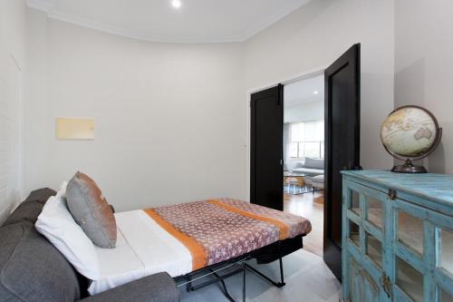 a bedroom with a bed and a blue dresser at Hidden Treasure in Fremantle