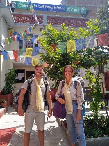 a man and a woman standing in front of a building at Best Hostel in Kathmandu