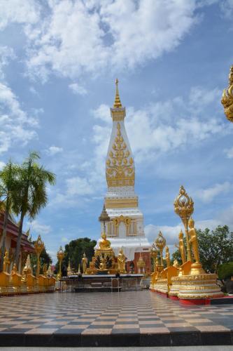 a large gold and white structure in a park at Baan Sabaijai Resort in That Phanom