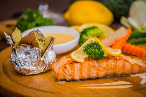 a plate of food with a fish and a bowl of soup at Cambana Residence in Siem Reap