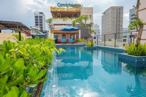 a swimming pool in the middle of a building at Babylon Garden Da Nang in Da Nang