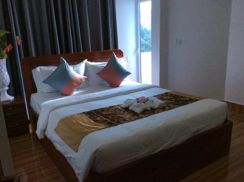 a bedroom with a bed with a stuffed animal on it at Realkhom Homestay in Siem Reap