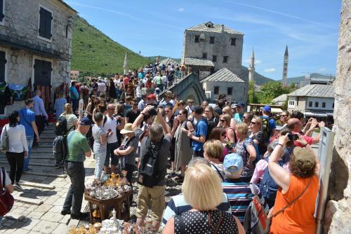 a large crowd of people standing in front of a castle at Five Rivers Rooms in Mostar