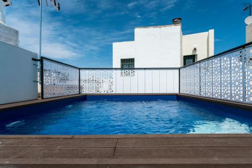 a swimming pool on the roof of a building at Unique House - Private SPA&Pool -StayInSeville in Seville