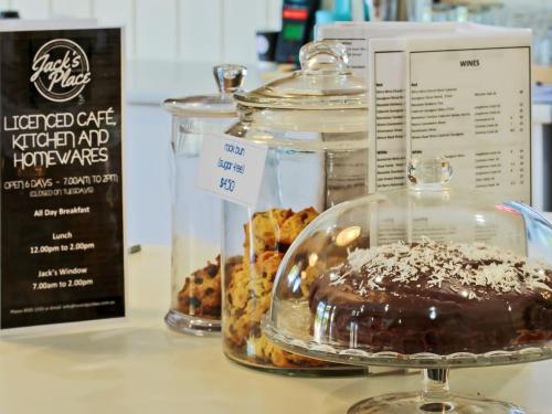 a glass jar of chocolate and other pastries on a counter at Motel Goolwa in Goolwa