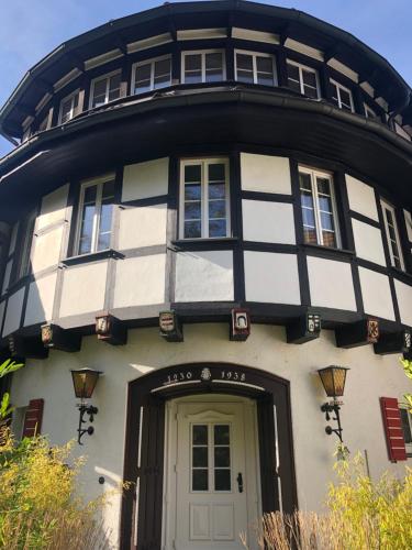 a black and white building with a door at Hotel & Gastropark Loemühle in Marl