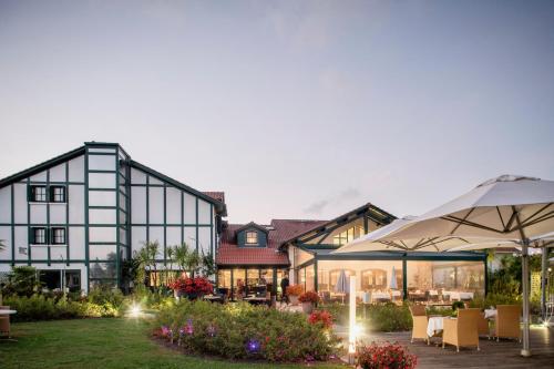 a view of the courtyard of a hotel with tables and umbrellas at Hotel Donibane Saint-Jean-de-Luz in Saint-Jean-de-Luz