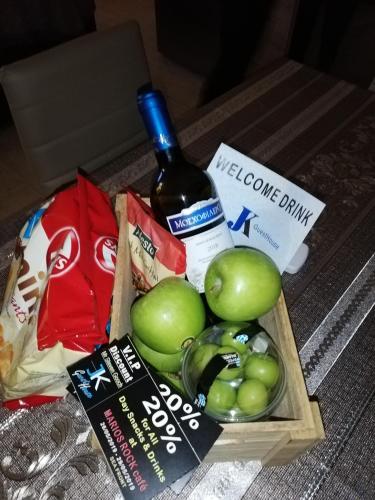 a crate of apples and a bottle of wine at JK's GUESTHOUSE KARDAMAINA in Kardamaina