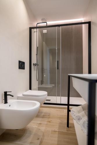 a bathroom with a toilet and a sink and a shower at Hotel Relax Family & Spa in San Benedetto del Tronto