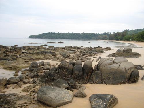 a group of rocks on a beach near the water at MJ Boutique Hotel Khao Lak in Khao Lak