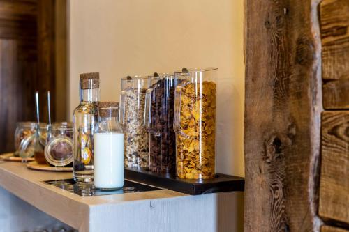 a shelf with bottles and glasses and a candle at Chalet Hotel Du Fornet in Val dʼIsère