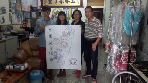 a group of people holding up a map at Checheng Backpackers Hostel in Checheng