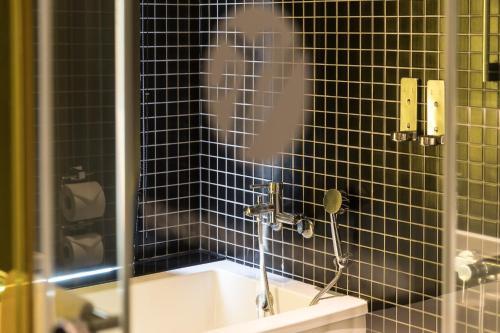 a bathroom with a shower with a sink at Vendome East Inn in Taipei