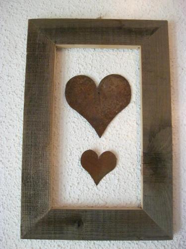 a picture of three hearts in a wooden frame at Appartements Bischof in Mellau