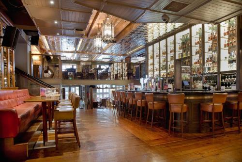 a bar in a restaurant with a lot of bar stools at Dinn Rí Hotel in Carlow