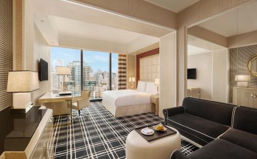 a hotel room with a bed and a desk at THE LIN Hotel in Taichung