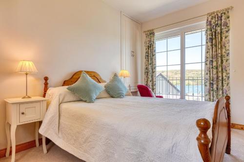 a bedroom with a large bed and a window at Shearwater Self Catering in Union Hall