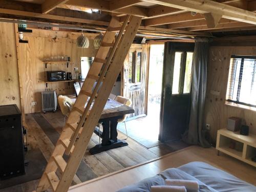 a ladder in a room with a table in it at Cabin in the Green - near Amsterdam in Velsen-Zuid