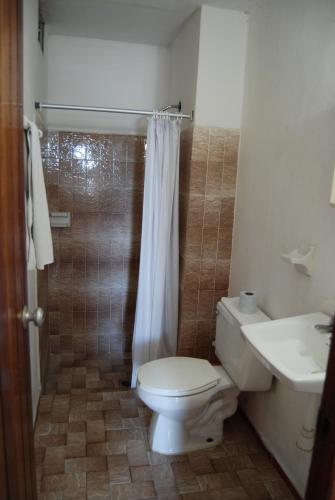 a bathroom with a toilet and a sink and a shower at Hotel Alux Cancun in Cancún