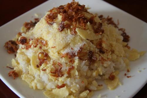 a white plate with a piece of cake with nuts at Lama Homestay in Hue