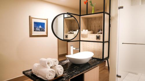 a bathroom with a sink and a mirror at Sea Passion Hotel in Koror