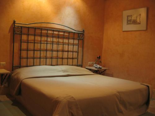 a bedroom with a bed with a metal head board at Miramar Sharm El Kantaoui ex Miramar Golf in Port El Kantaoui