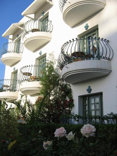 a building with balconies and flowers in front of it at Miramar Sharm El Kantaoui ex Miramar Golf in Port El Kantaoui