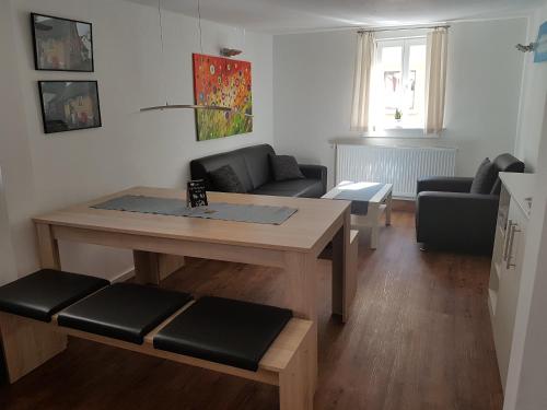 a living room with a table and a couch at Ferienhaus Nr. 10 in Buergstadt
