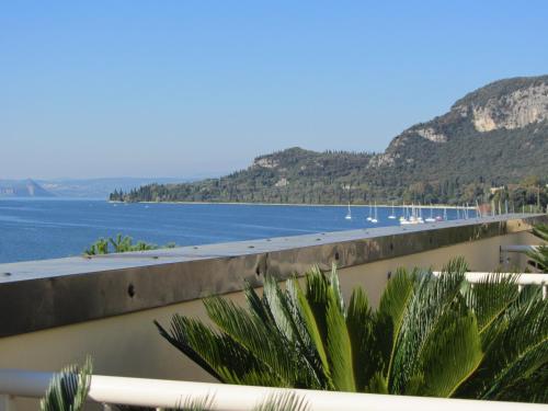 a view of a body of water with mountains at Hotel Roma in Garda