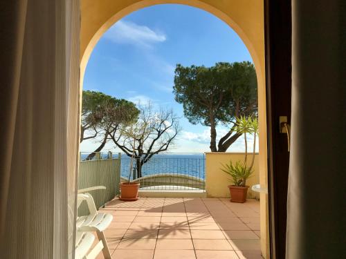 an open door to a patio with a view of the ocean at Hotel Roma in Garda