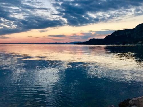 a view of a large body of water at sunset at Hotel Roma in Garda