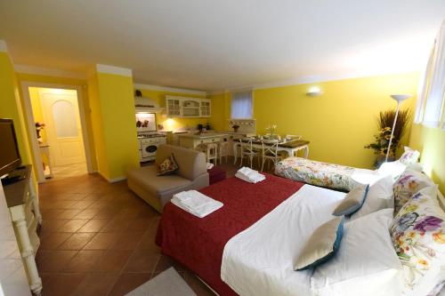 a bedroom with a large bed and a kitchen at Villa Campo dei Fiori in Casciago