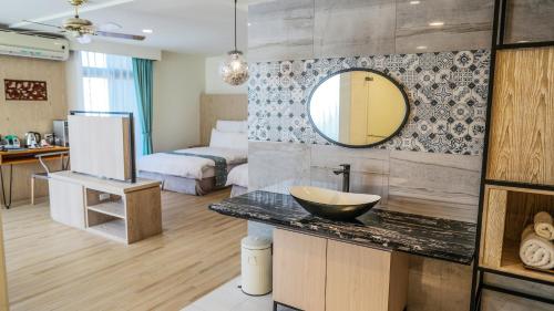 a bathroom with a sink and a mirror in a room at Sea Passion Hotel in Koror