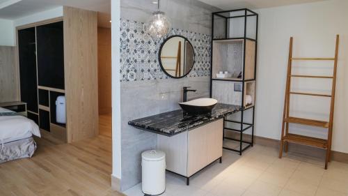 a bathroom with a sink and a mirror at Sea Passion Hotel in Koror