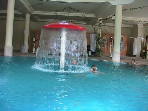 a group of children swimming in a pool with a fountain at Miramar Sharm El Kantaoui ex Miramar Golf in Port El Kantaoui