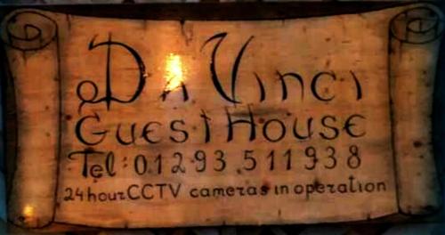 a sign for a guest house on a wall at Da Vinci Guest House & Guest Parking, A Real Gem in Crawley