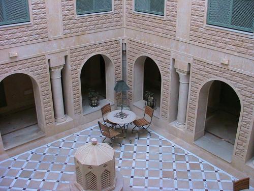 an aerial view of a building with a table and chairs at Miramar Sharm El Kantaoui ex Miramar Golf in Port El Kantaoui