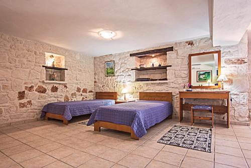 A bed or beds in a room at The Vivian - Luxury Stone Villa