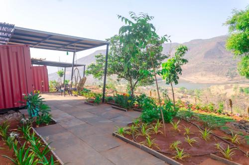 a patio with a view of a mountain at Avanti Kalagram Hill Top Resort, Mulshi in Kolvan