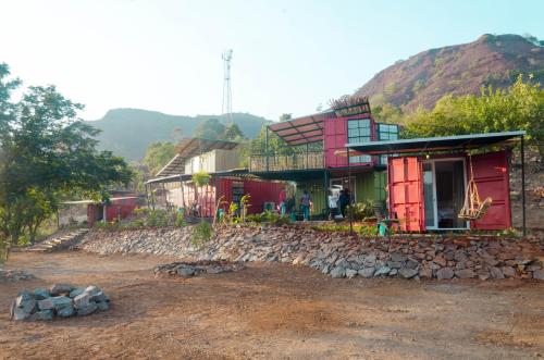 a house on top of a hill with a rock at Avanti Kalagram Hill Top Resort, Mulshi in Kolvan