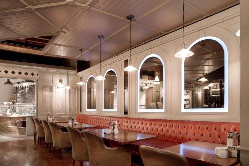 a dining room with tables and chairs and windows at Dinn Rí Hotel in Carlow