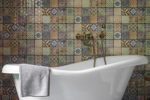 a bath tub with a faucet in a bathroom at Bird Valley in Sinyak