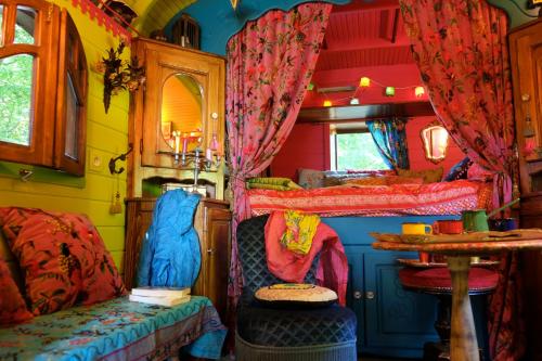 a room with two bunk beds in a bus at La Roulotte de Sandor in Quintigny