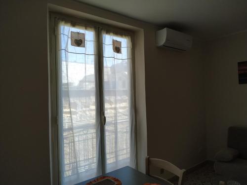 a window with white curtains in a room at Aspra al delfino blu in Bagheria