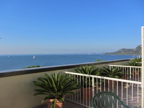 a balcony with a view of the ocean at Hotel Roma in Garda