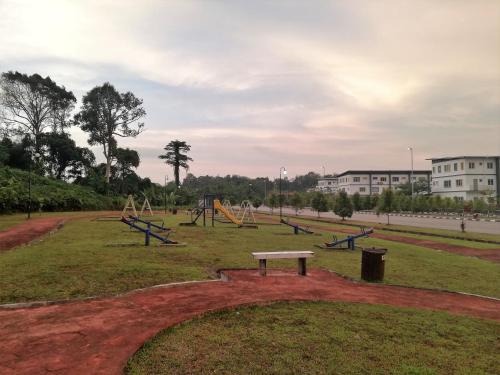 an empty playground with a bench in a park at Hornbill Homestay Samarahan in Kota Samarahan