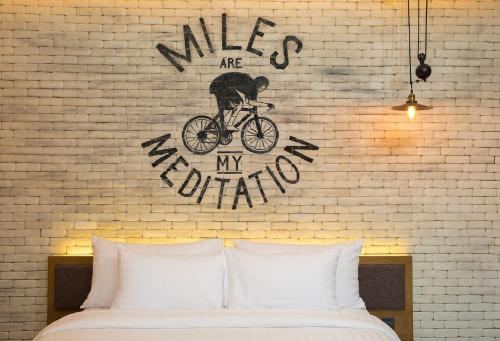 a bedroom with a wall with a bike on it at Wheeler Bed &Bike in Bangsaen